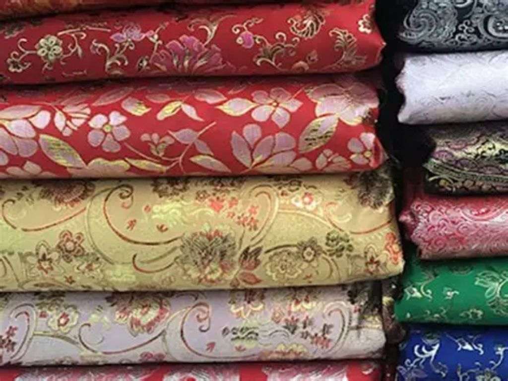 Brocade features intricate patterns woven directly onto the surface.