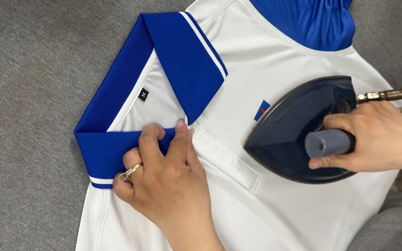 The placket ironing step before button attachment is always carefully prioritized