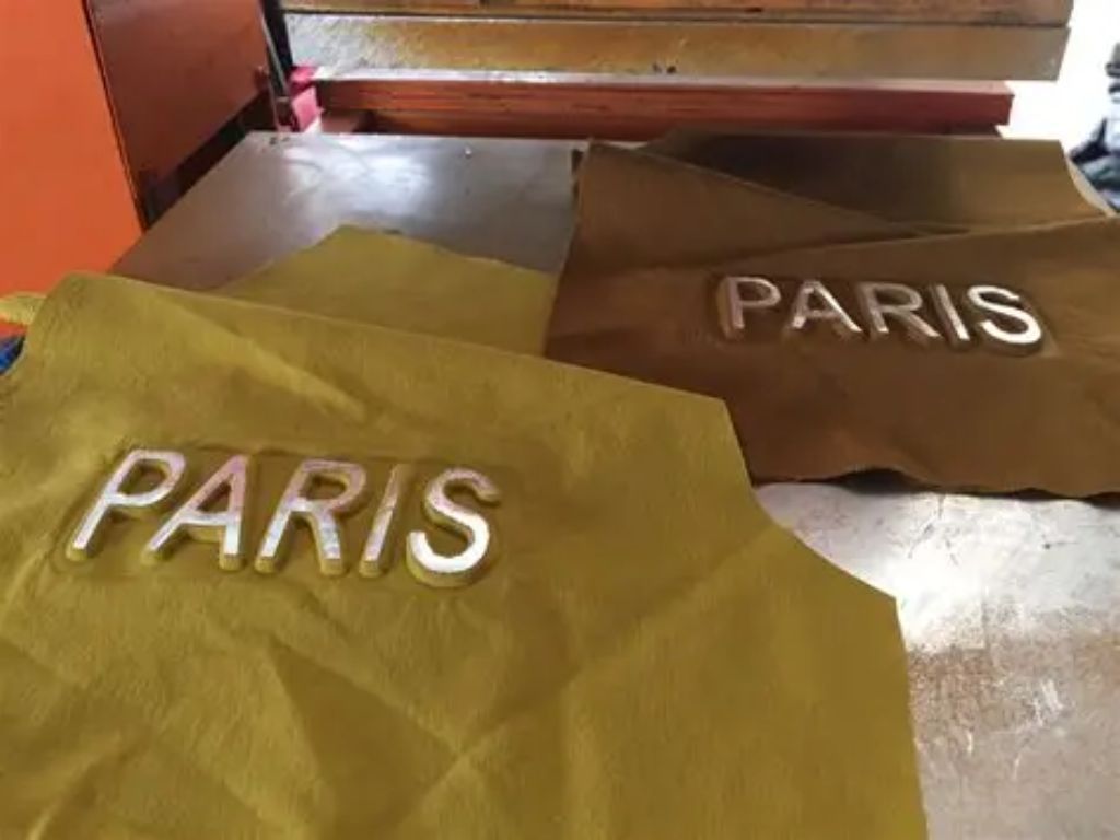 Embossed printing is the process of “adding” extra material onto the surface of the fabric